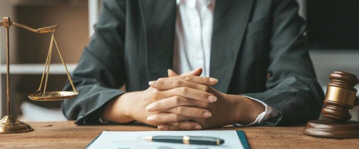 A woman lawyer sits in the office of her law firm