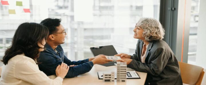 Couple Receiving Money from Advisor in Office Setting